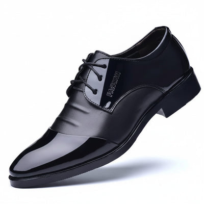 Black leather dress shoe on a white background