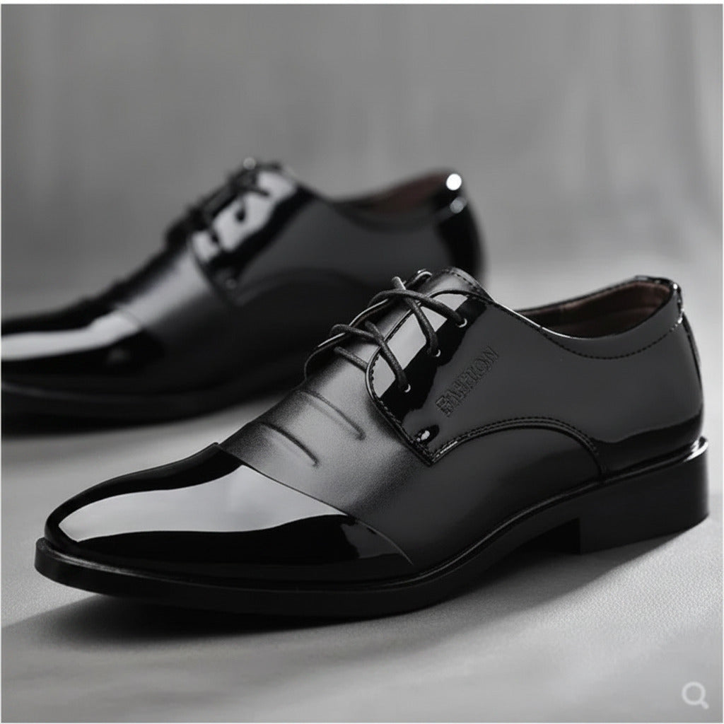 Black dress shoes on a gray background