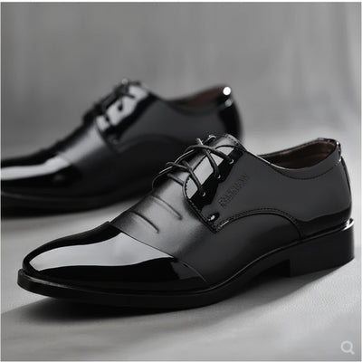 Black dress shoes on a gray background