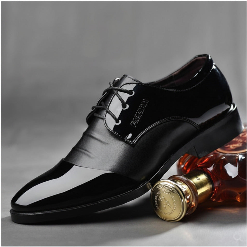 Black dress shoe with a bottle of perfume on a gray background