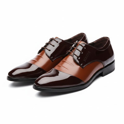 Brown dress shoes with black soles on a white background