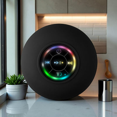 TS Store black waterproof Bluetooth speaker with suction cup and colorful LED lights, featuring playback controls and power button.